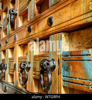 Details of a wooden chest made of recycled old ship planks with rivets and metal rings. Stock Photo