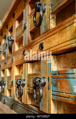 Details of a wooden chest made of recycled old ship planks with rivets and metal rings. Stock Photo