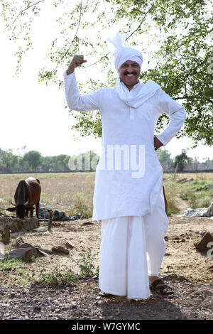 Rural Man standing with his hand on hip Stock Photo