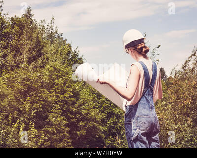 Woman holding paper project in the park Stock Photo