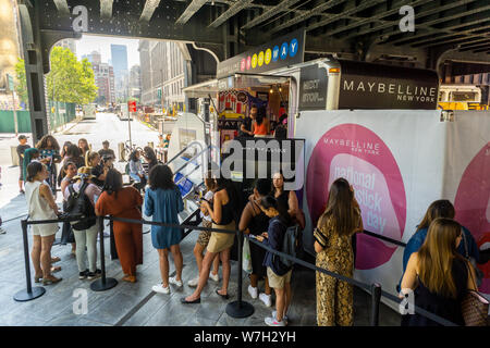 Visitors celebrate National Lipstick Day at a Maybelline pop-up branding event in Hudson Yards in New York on Monday, July 29, 2019. The Maybelline On The Way Pop-Up offered free samples of the comapny’s lipstick as well as mini-brow makeovers. Maybelline is a brand of L’Oreal with its headquarters located in 10 Hudson Yards.(© Richard B. Levine) Stock Photo