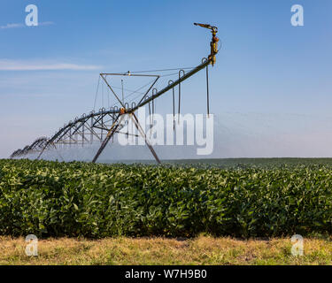 Closeup of center pivot irrigation system watering soybean farm field. hot weather and little rain is creating drought conditions in parts of Illinois Stock Photo