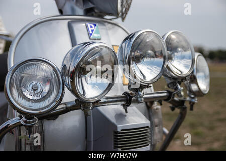 A close up of the chrome headlights on a vintage moped or scooter Stock Photo