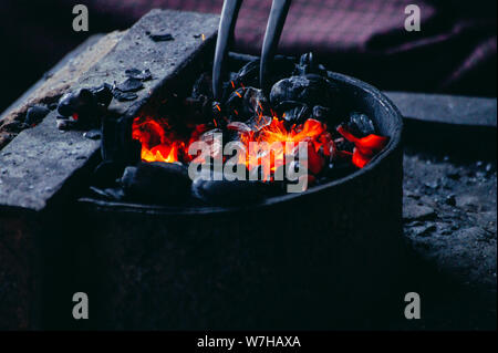 Blacksmith Furnace Burning Coals Tools Glowing closeup Stock Photo