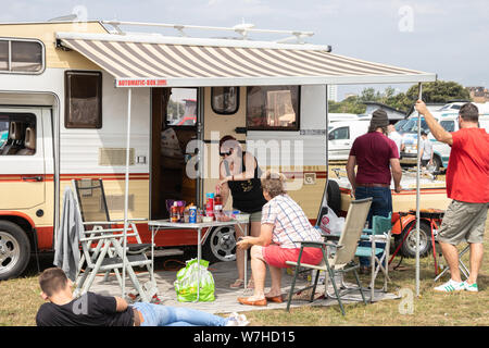 A family enjoying camping with their caravan and awning Stock Photo