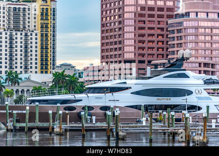 Luxury superyacht at Town Docks marina in Palm Beach, Florida with West Palm Beach waterfront towers in background. (USA)