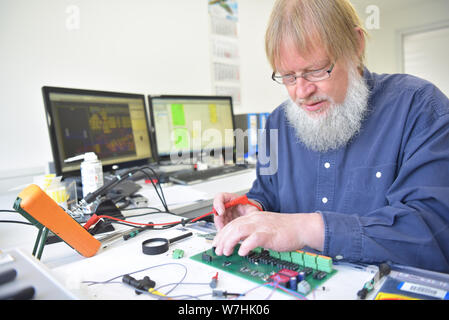 engineer at the workplace - assembly and development of electronics in a modern factory Stock Photo