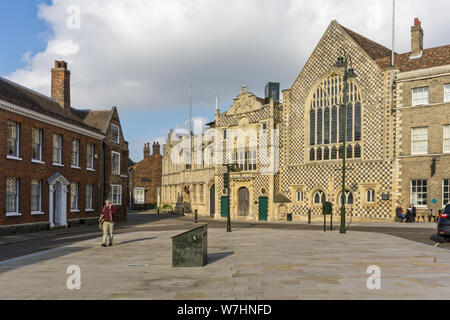 View across the Saturday Market Place  with the historic Trinity Guildhall and Town Hall to the right; Kings Lynn, Norfolk, UK Stock Photo