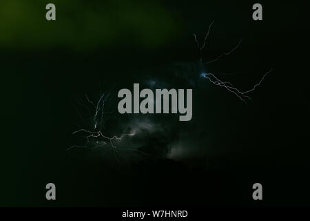 Storm - strong thunderbolt with green flashes during night in Pyrenees, Spain. Stock Photo