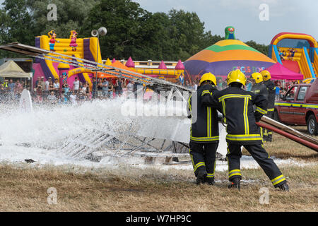 Arena display demonstrating how to put out an airplane fire with water hoses at the Odiham Fire Show, 2019, in Hampshire, UK Stock Photo