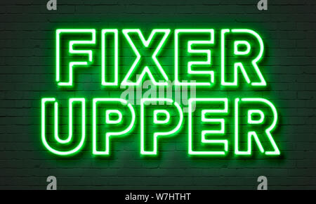 Fixer upper neon sign on brick wall background Stock Photo