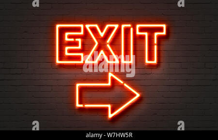 Exit neon sign on brick wall background Stock Photo