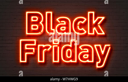 Black Friday neon sign on brick wall background Stock Photo