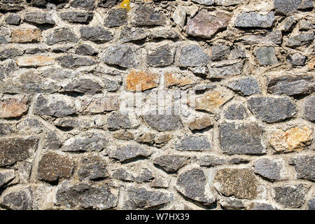 Old stone wall. Granite Wall Surface Stock Photo