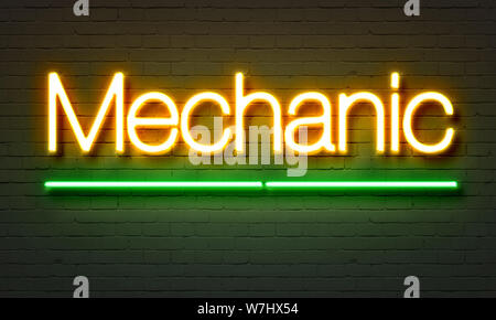 Mechanic neon sign on brick wall background Stock Photo