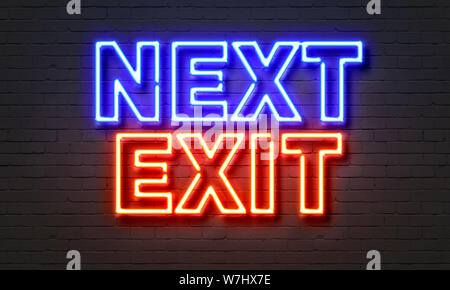 Next exit neon sign on brick wall background Stock Photo