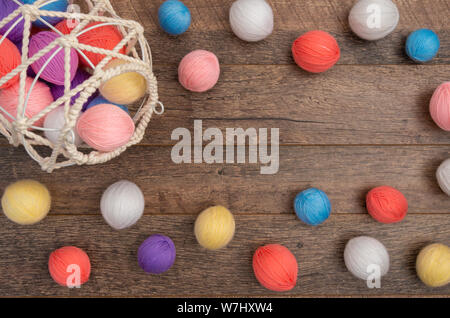 Scattered colorful yarn balls on flat lay, top view Stock Photo