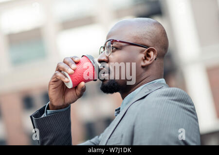 Young African-American businessman thinking and drinking coffee Stock Photo