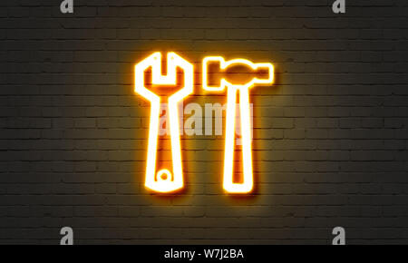 Tools neon sign on brick wall background Stock Photo