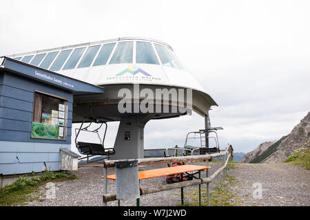 The Sareis gondola (Bergbahn) chairlift station overlooks the Alps in Malbun, Liechtenstein, as fog rolls in on a rainy day. Stock Photo