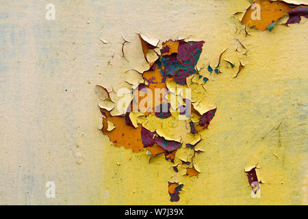 rusty metal sheet with peeling layers of paint of different colours - a surface texture photo Stock Photo
