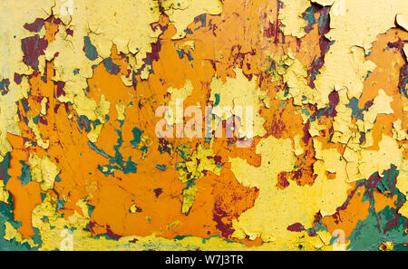 rusty metal sheet with peeling layers of paint of different colours - a surface texture photo Stock Photo