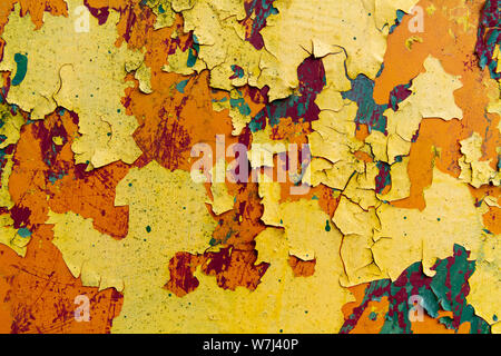 rusty metal sheet with peeling layers of paint of different colours - a surface texture photo Stock Photo