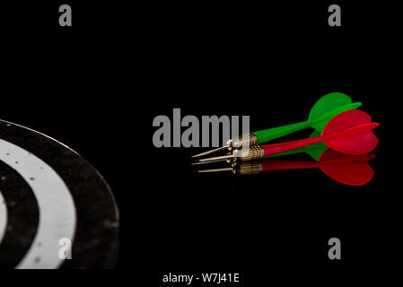 Colored arrows on a black background and target. Hit the target. Stock Photo
