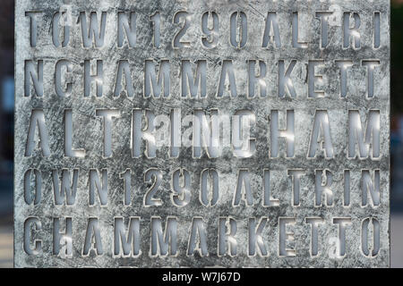 A metal slab acting as a gateway sign welcoming people to the town of Altrincham, Cheshire, UK. Stock Photo