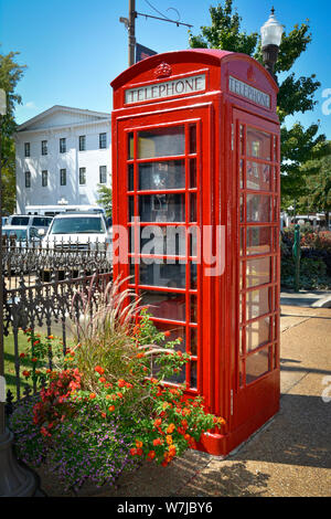 The iconic British red telephone box on Courthouse Square alongside  City Hall, with historic Lafayette County Courthouse in background, Oxford, MS Stock Photo
