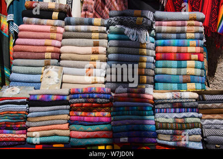 Alpaca scarves, shawls and clothing, tourist souvenirs, Pisac, Peru Stock Photo