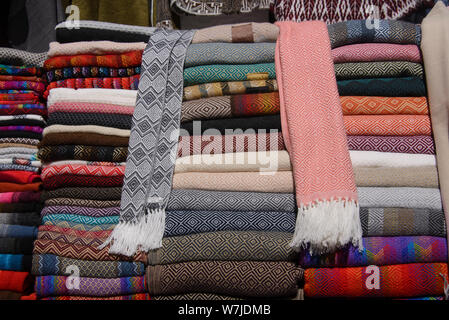 Alpaca scarves, shawls and clothing, tourist souvenirs, Pisac, Peru Stock Photo