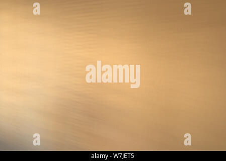 An empty wall with a light gradient created by shadows streaking across it. Stock Photo