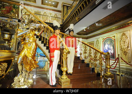 Chinese employees dressed in royal palace servant costumes pose in a replica of the 'Palace of Versailles', a Baroque art museum turned from a factory Stock Photo