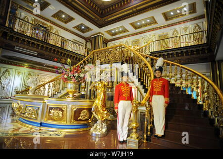 Chinese employees dressed in royal palace servant costumes pose in a replica of the 'Palace of Versailles', a Baroque art museum turned from a factory Stock Photo