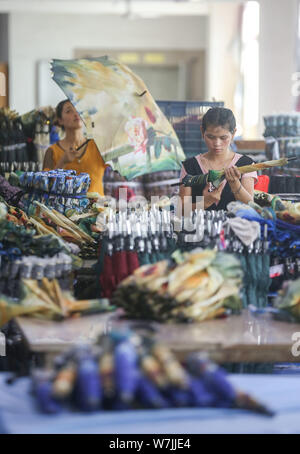 --FILE--Chinese factory workers check new cars on the assembly line at ...