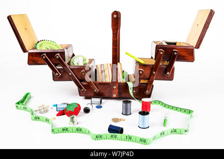 Vintage Wooden Sewing Box for storage of accessories like needles, utensils, thimble, yarn, pins, pin cushion.. Isolated against white background Stock Photo