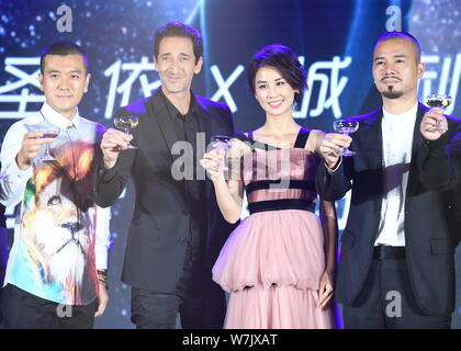 (From left) Yang Zi, president of China Juli Entertainment Media Co., Ltd. and the husband of Huang Shengyi, American actor and producer Adrien Brody, Stock Photo