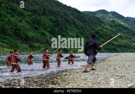 A Chinese villager of Miao ethnic group wearing traditional costumes  practises ''Miao stickfighting'', a unique martial art of the Miao Martial  Arts i Stock Photo - Alamy