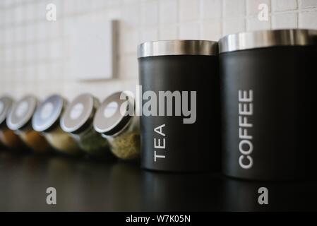 Closeup shot of black jars of tea and coffee in a cafe Stock Photo