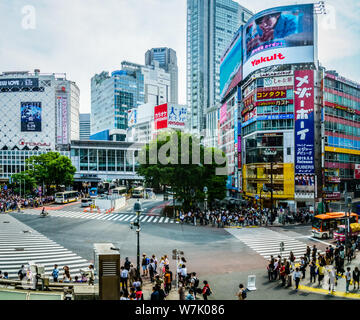 Shibuya pedestrian crossing with people and 109 building in