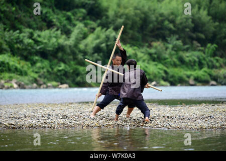 A Chinese villager of Miao ethnic group wearing traditional costumes  practises ''Miao stickfighting'', a unique martial art of the Miao Martial  Arts i Stock Photo - Alamy