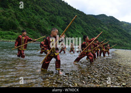 A Chinese villager of Miao ethnic group wearing traditional costumes  practises ''Miao stickfighting'', a unique martial art of the Miao Martial  Arts i Stock Photo - Alamy