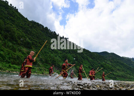 A Chinese villager of Miao ethnic group wearing traditional costumes  practises ''Miao stickfighting'', a unique martial art of the Miao Martial  Arts i Stock Photo - Alamy