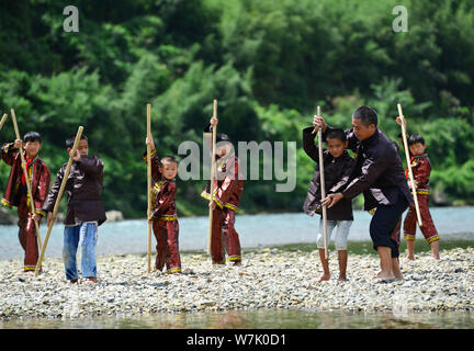 A Chinese villager of Miao ethnic group wearing traditional costumes  practises ''Miao stickfighting'', a unique martial art of the Miao Martial  Arts i Stock Photo - Alamy