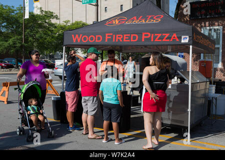 Customers gather around the Alto Grado Food and Beverage Company's tent at Fort Wayne's Farmers Market in downtown Fort Wayne, Indiana, USA. Stock Photo