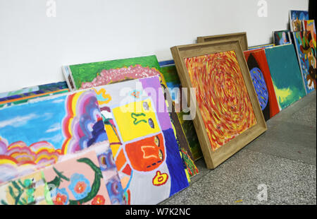 Colorful paintings created by children with mental and intellectual disabilities as a part of a charity project titled 'Enlighten Life with Art' initi Stock Photo