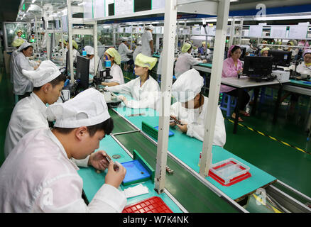 --FILE--Female Chinese workers produce electric products on the assembly line at a factory in Huaibei city, east China's Anhui province, 21 September Stock Photo