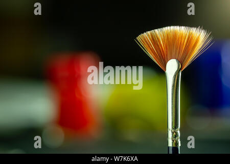 Closeup artist paint brush and poster color bottle blur background. Copy space for text. Concept of art education.