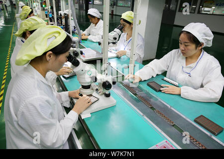 --FILE--Female Chinese workers produce electric products on the assembly line at a factory in Huaibei city, east China's Anhui province, 21 September Stock Photo